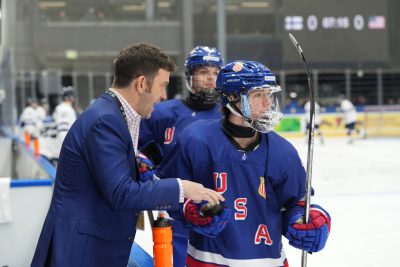 Coach helping an ice hockey athlete