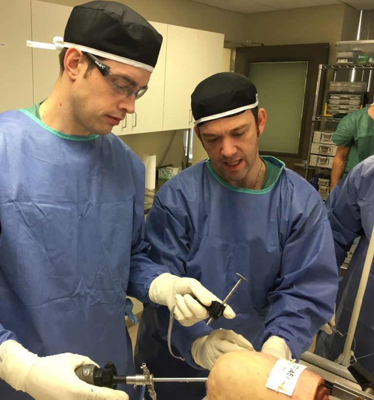 Doctor teaching another doctor in an operation room